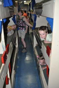 Aurelia, Lucas, and Isabella try out the bunks on the USS Missouri