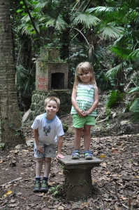 Aurelia and Lucas posing at a column base at the plantation